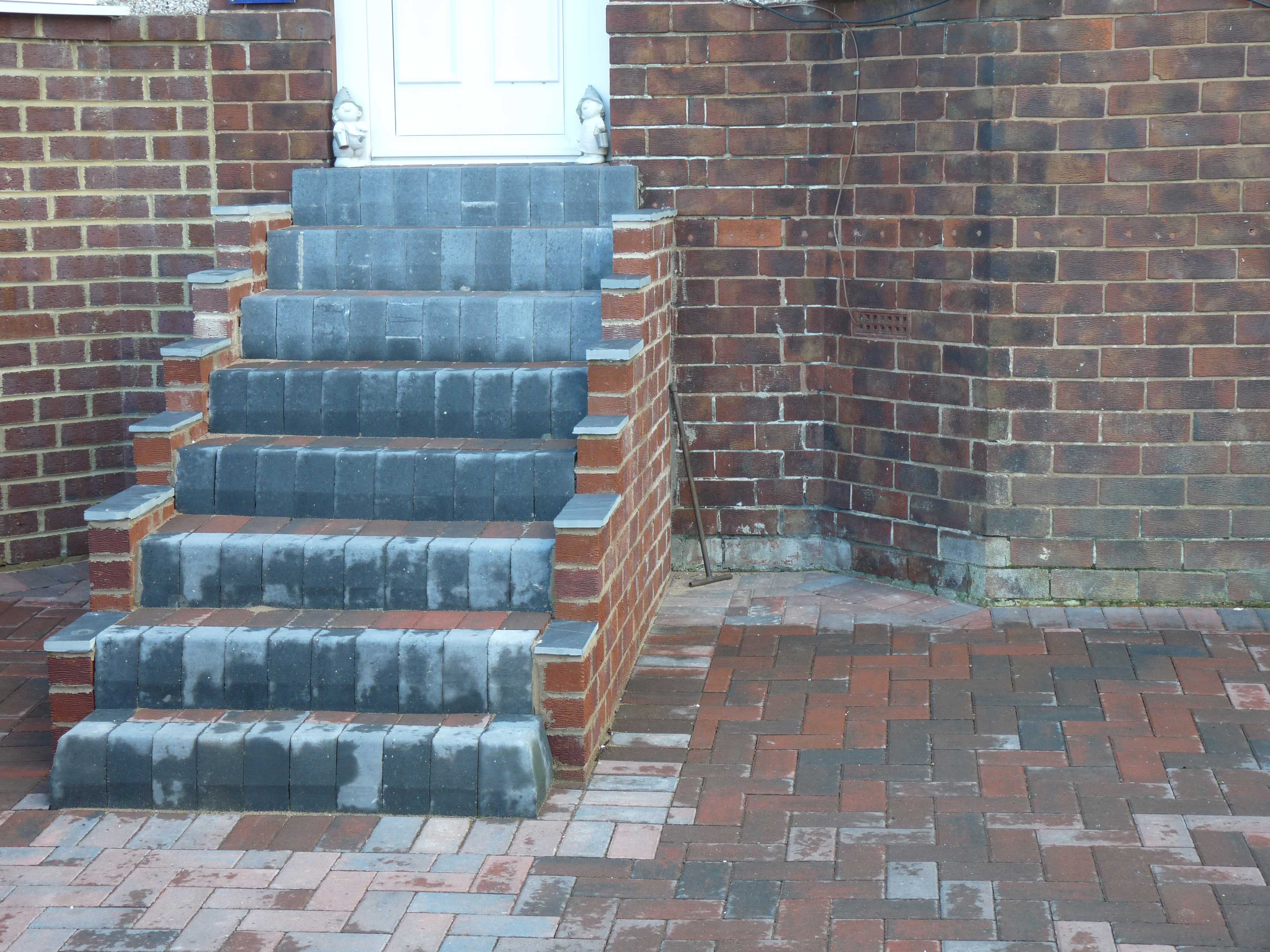 Driveway standard paving. Construction of front entrance, steps, curves, wall and sideway to house